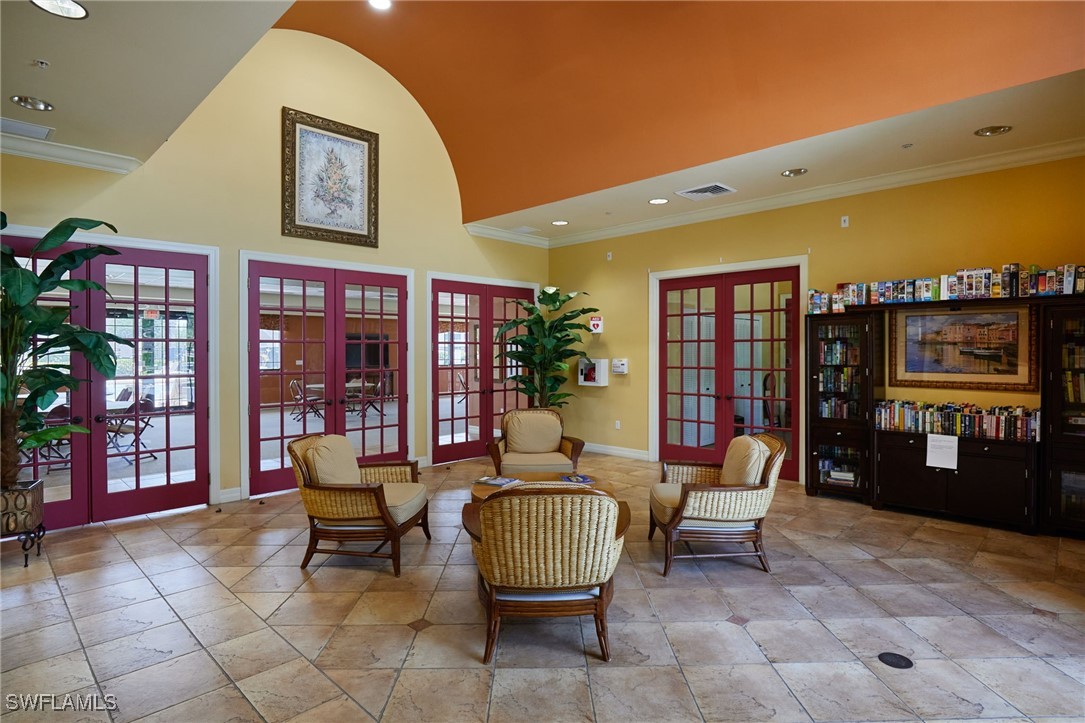 8550 Kingbird Loop, Unit 637 Estero, FL 33967 - Photo 31 of 35 a living room with furniture a bookshelf and a wooden floor
