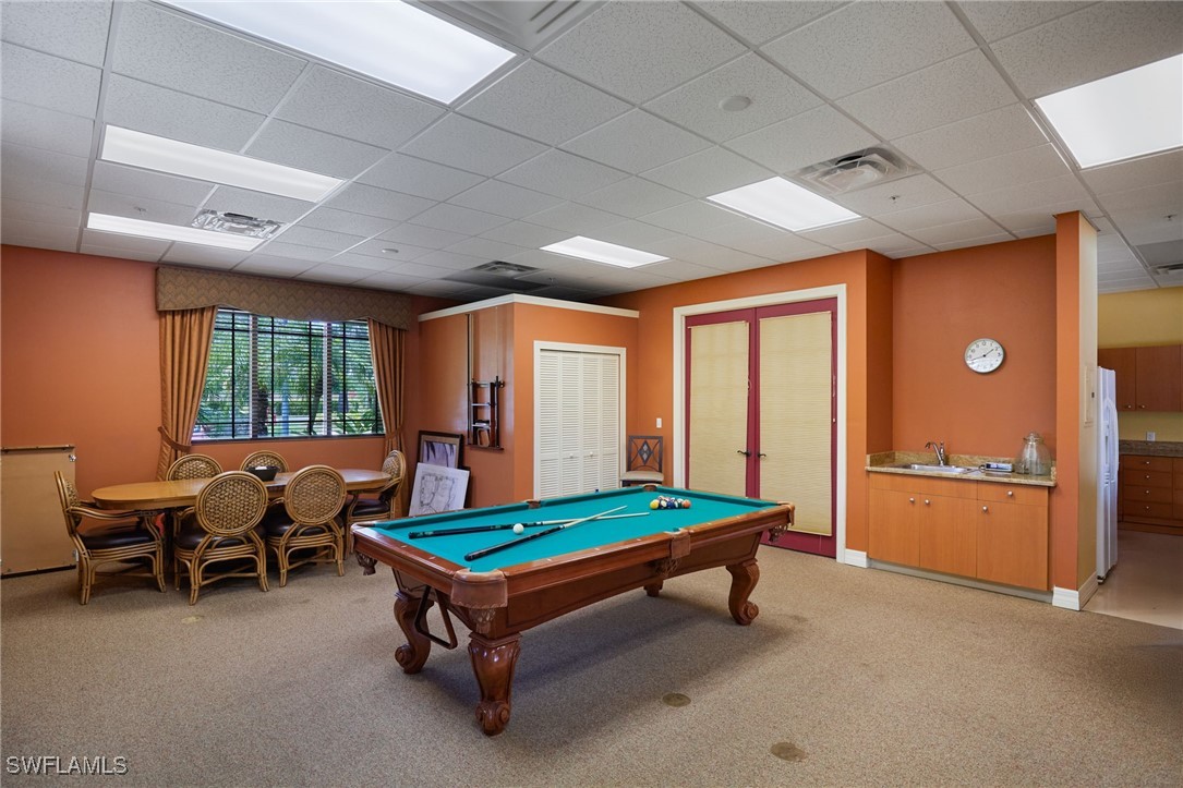 8550 Kingbird Loop, Unit 637 Estero, FL 33967 - Photo 33 of 35 a living room with furniture pool table and a window