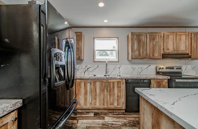 a kitchen with a stove a sink and a refrigerator