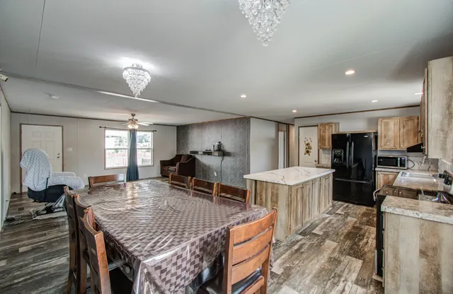 a kitchen with a table and chairs in it