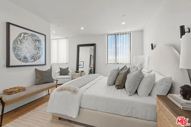 a bedroom with a large bed and a couch