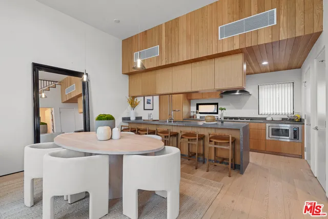 a kitchen with a sink a stove and chairs