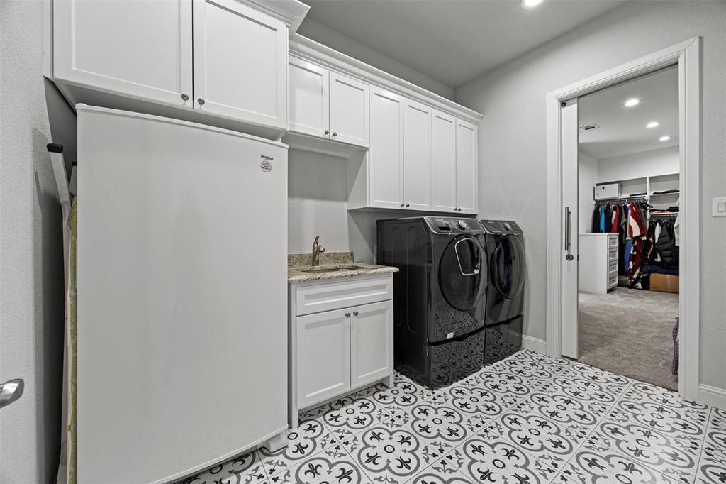 6381 Rigel Road Godley, TX 76044 - Photo 32 of 40 a kitchen with a refrigerator and cabinets