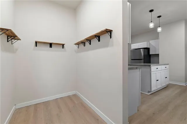 a view of an empty room with window and fire place