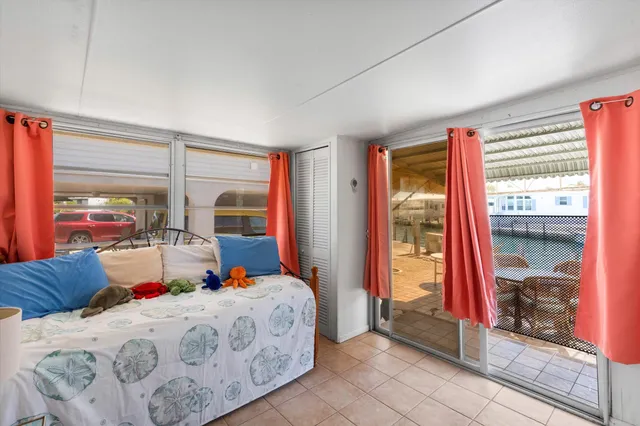 a bedroom with a bed and a large window