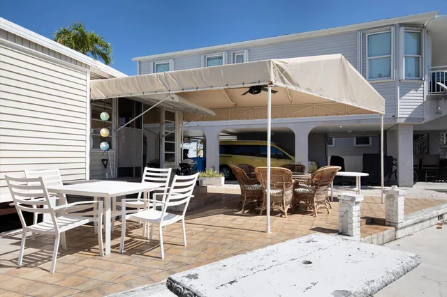 a view of a dining table and chairs in the patio