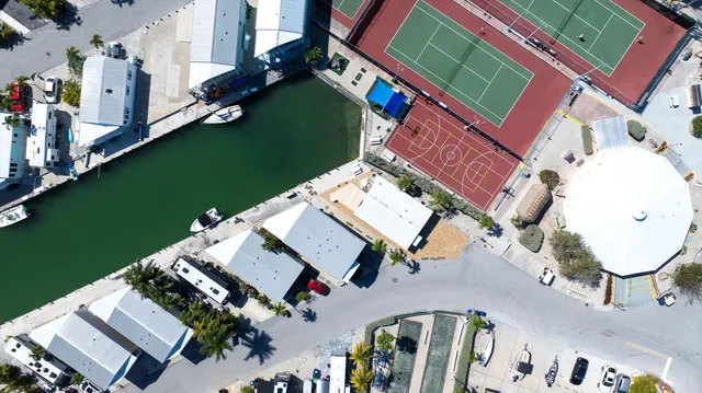 an aerial view of a house with outdoor space and a lake view