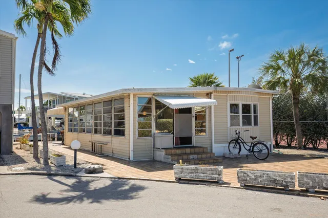 a front view of a house with porch and outdoor seating