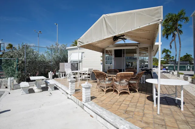 a view of a dinning table and chairs in the patio