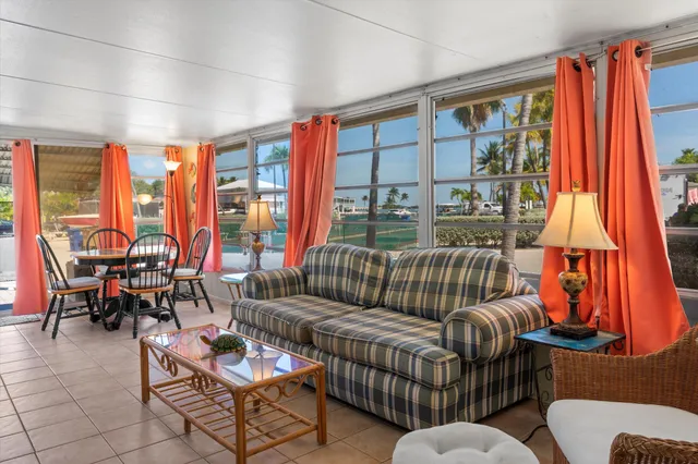 a living room with furniture and a floor to ceiling window