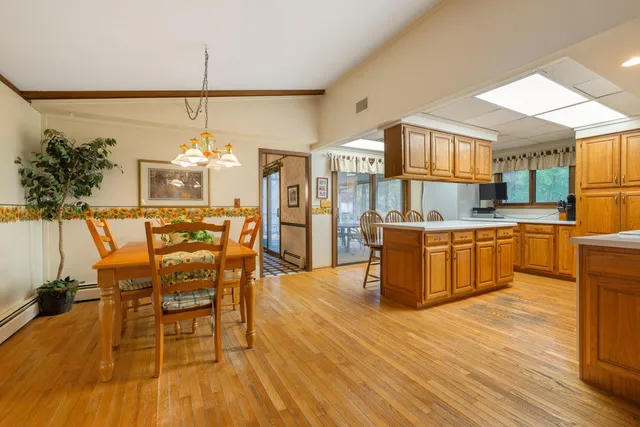 a large kitchen with a table and chairs