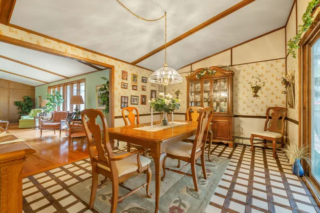 a dining room with furniture and wooden floor