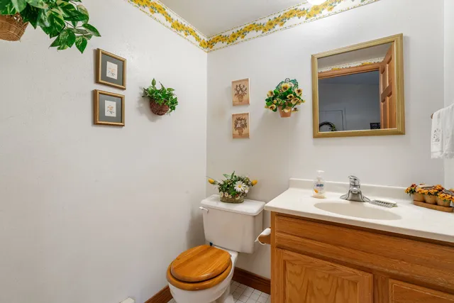 a bathroom with a toilet a sink and mirror