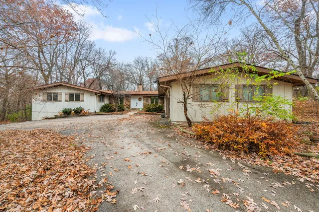 a yellow house with trees in front of it
