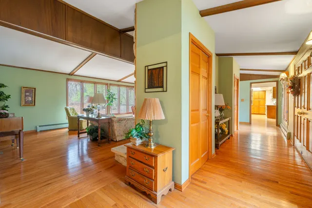 a dining room with wooden floor and a table