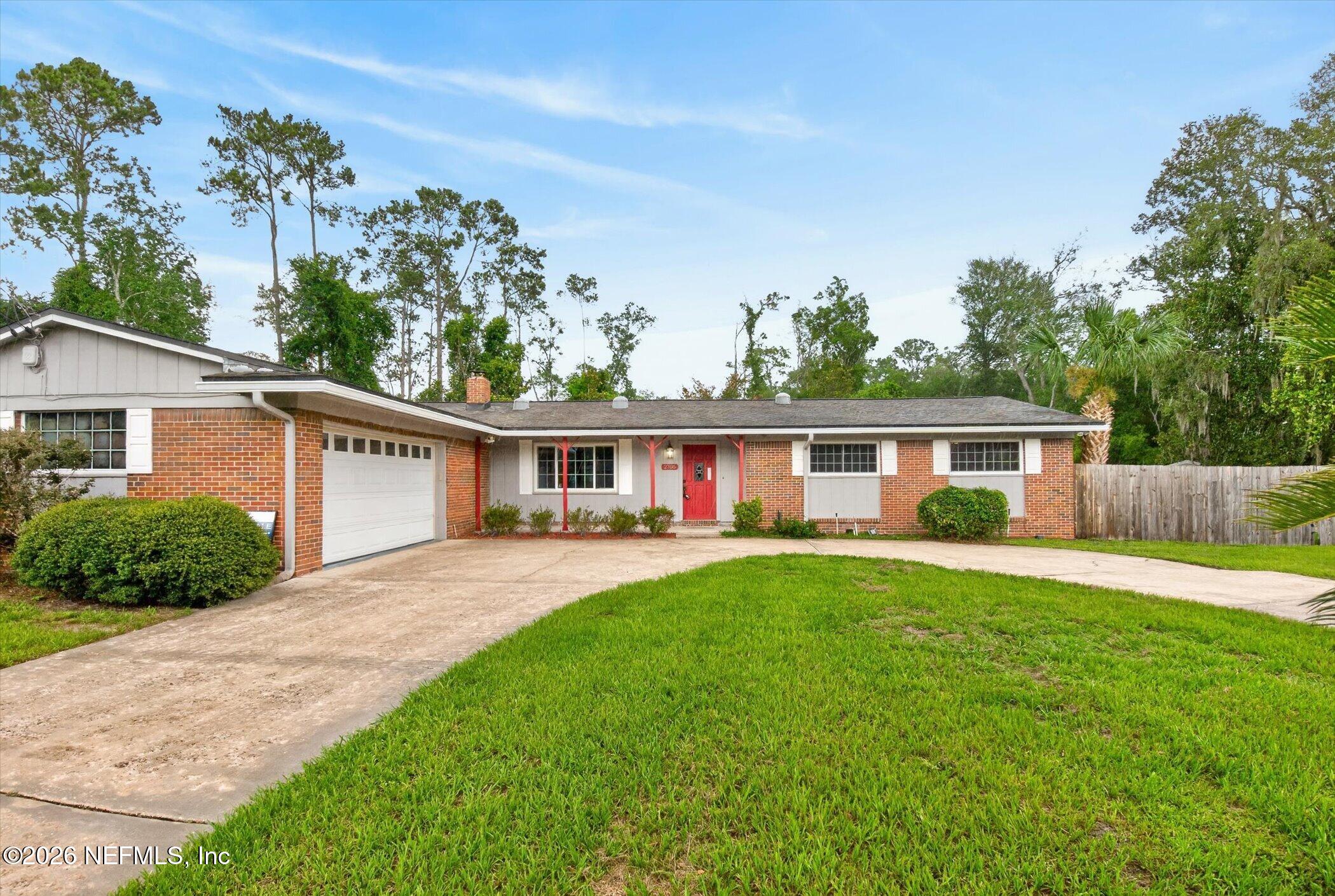 2705 Navajo Road Orange Park, FL 32073 - Photo 6 of 58 a front view of a house with a garden