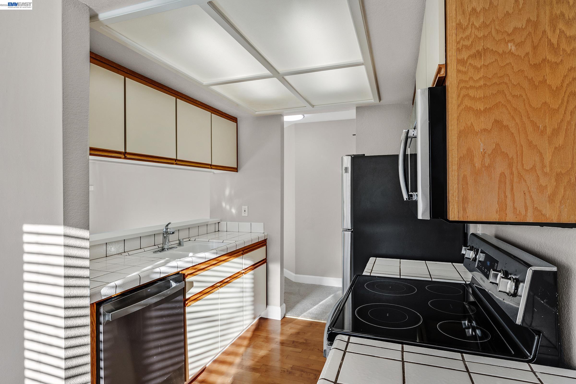 3769 Crow Canyon Road San Ramon, CA 94582 - Photo 20 of 56 a kitchen with granite countertop a stove and a sink