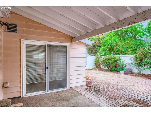 a backyard of a house with plants and trees
