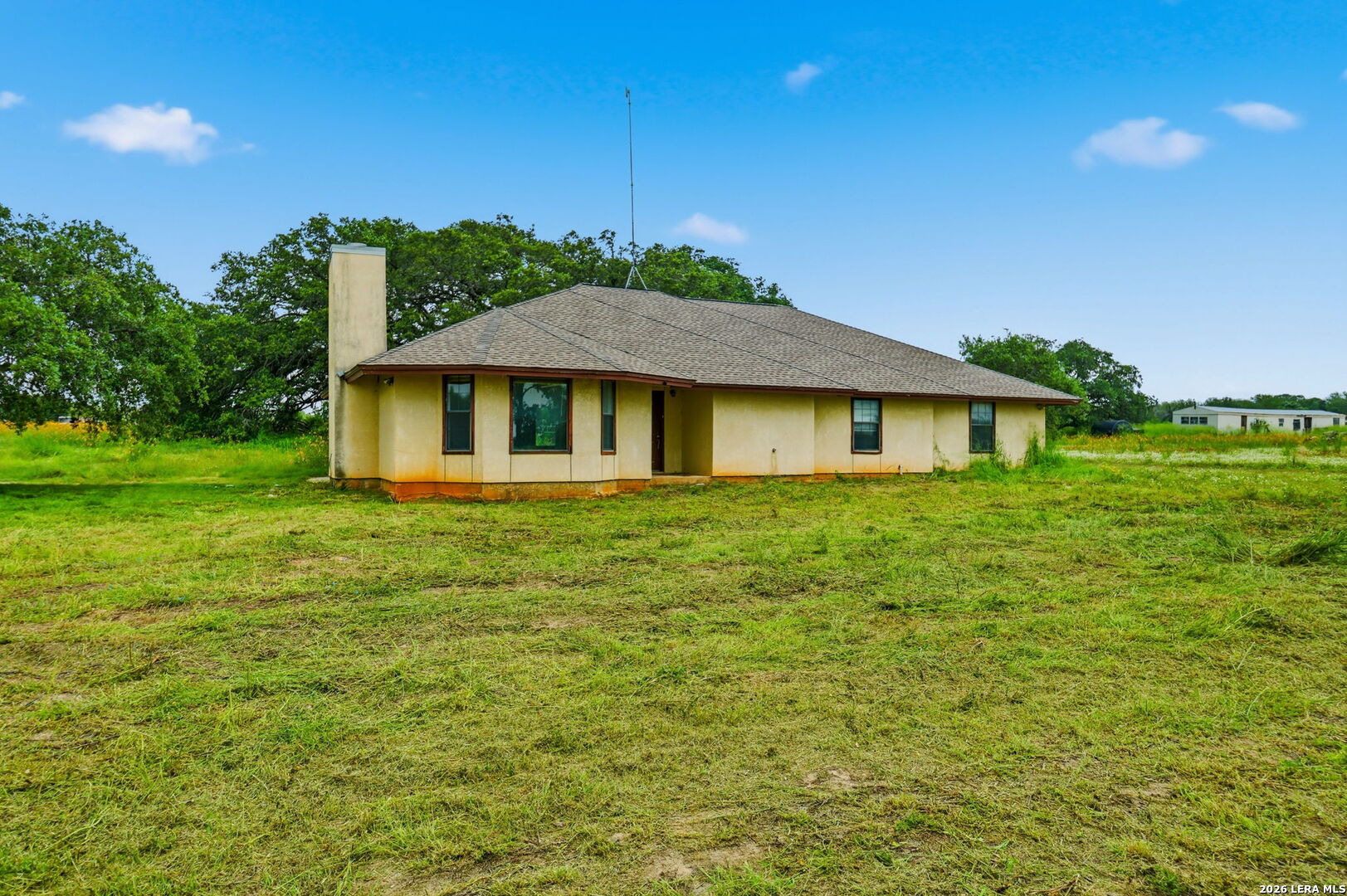 3061 Horse Ranch Road San Antonio, TX 78264 - Photo 27 of 34 a front view of a house with a garden
