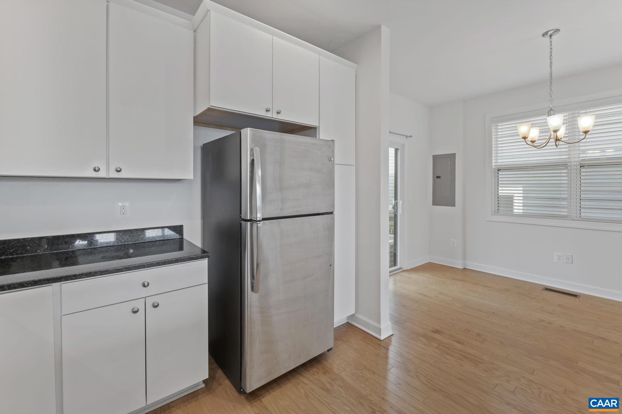 1429 Midland Street Charlottesville, VA 22902 - Photo 13 of 33 a kitchen with granite countertop white cabinets and refrigerator