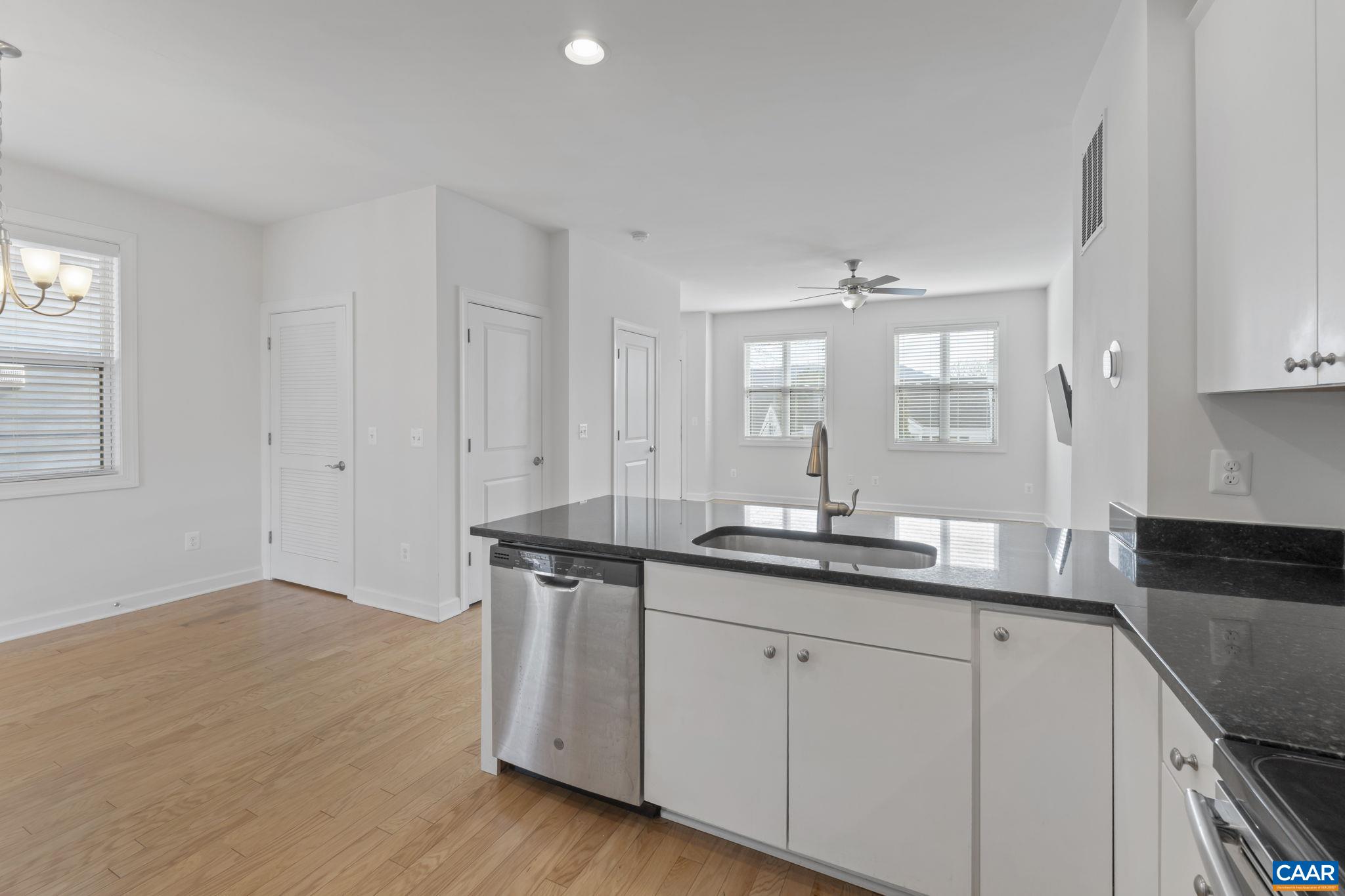1429 Midland Street Charlottesville, VA 22902 - Photo 14 of 33 a kitchen with granite countertop white cabinets and a sink