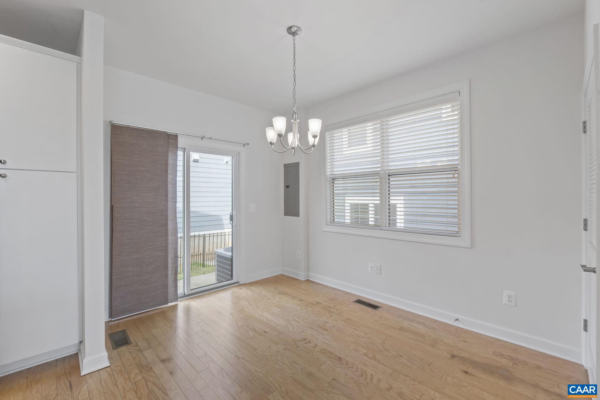 1429 Midland Street Charlottesville, VA 22902 - Photo 15 of 33 a view of an empty room with wooden floor and a window