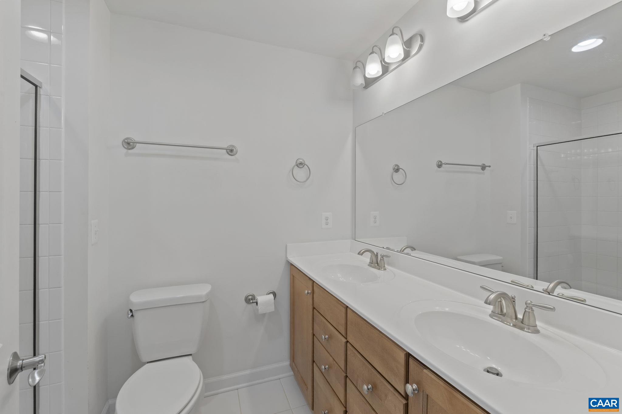 1429 Midland Street Charlottesville, VA 22902 - Photo 25 of 33 a spacious bathroom with a double vanity sink a toilet and a mirror