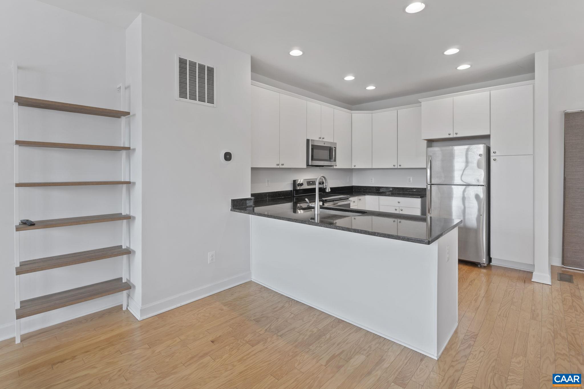 1429 Midland Street Charlottesville, VA 22902 - Photo 10 of 33 a kitchen with kitchen island a counter top space and a refrigerator