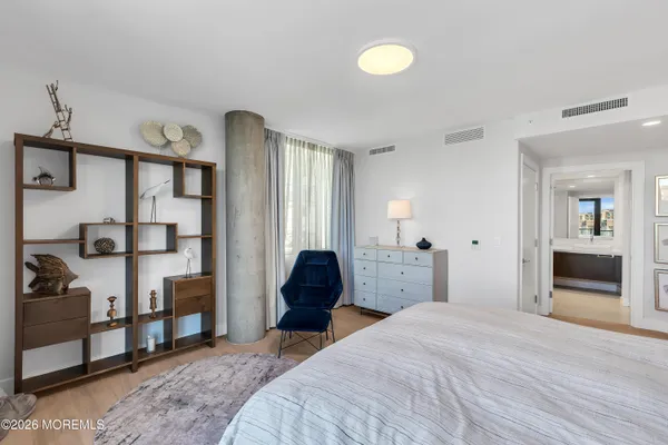 a bedroom with a large bed and a window