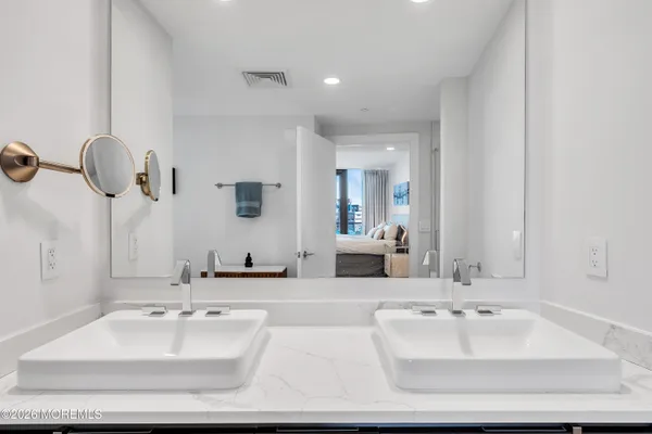 a bedroom with a bed and a sink