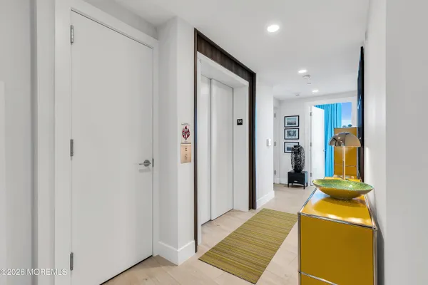 a view of a hallway with kitchen view