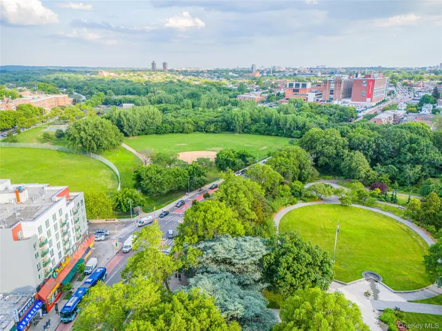 a view of a swimming pool with a yard and outdoor seating