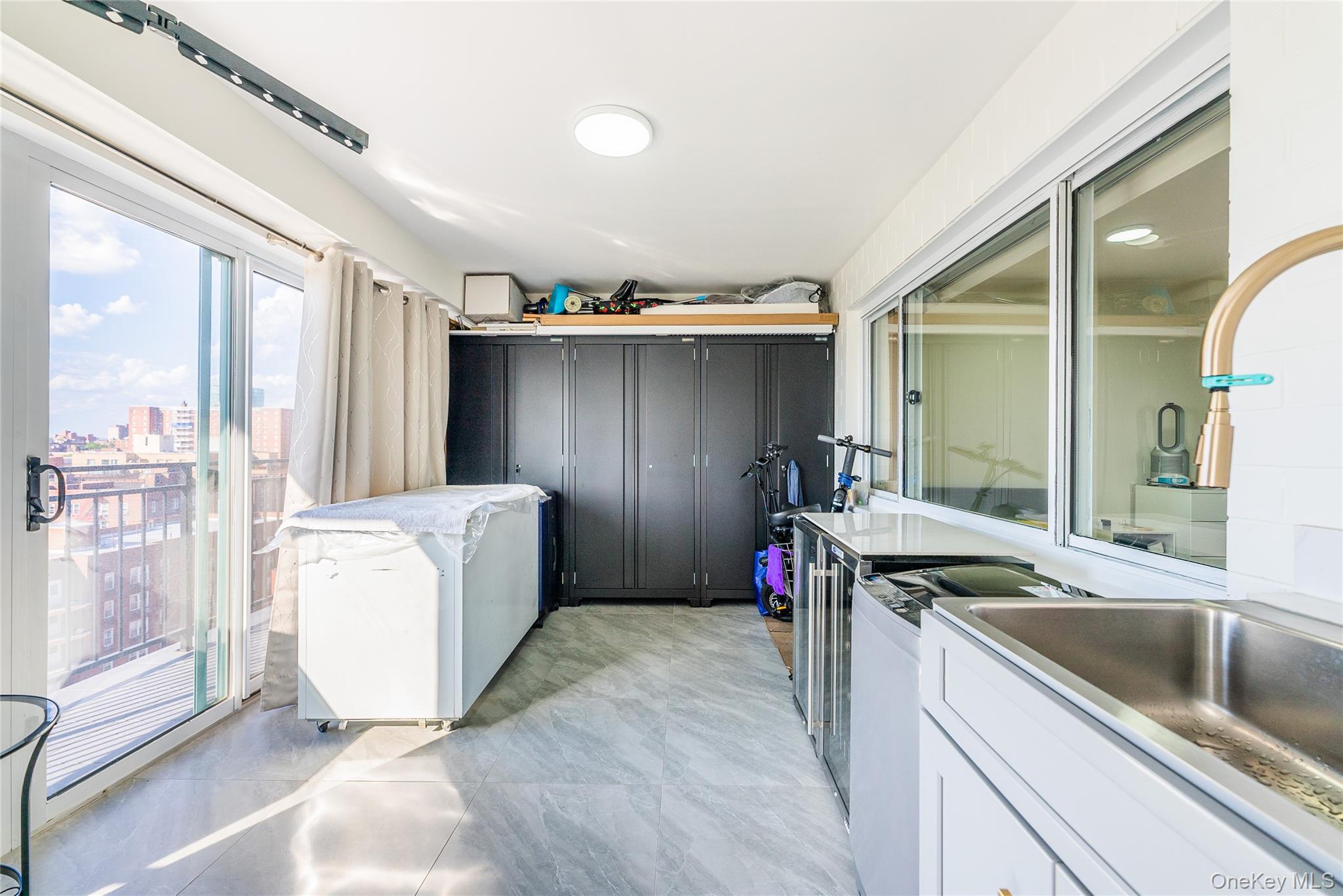 43-18 Main Street, Unit 12A Queens, NY 11355 - Photo 12 of 32 a kitchen with a sink and refrigerator