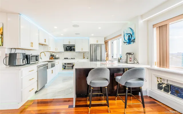 a kitchen with white cabinets and appliances