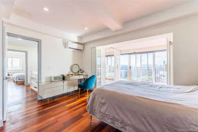 a bedroom with a bed a rug and a large window