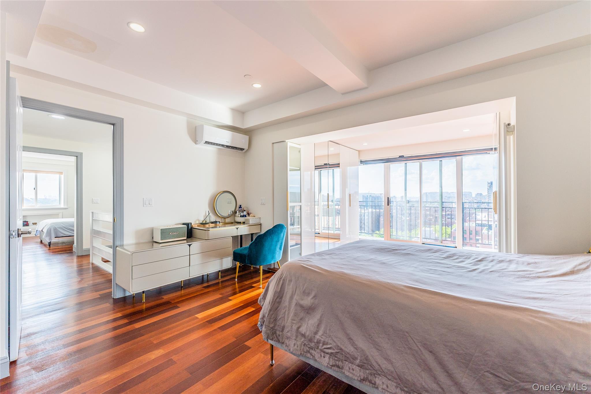 43-18 Main Street, Unit 12A Queens, NY 11355 - Photo 22 of 32 a spacious bedroom with a bed and wooden floor