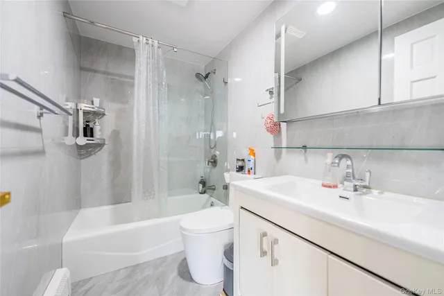 a spacious bedroom with a bed and wooden floor