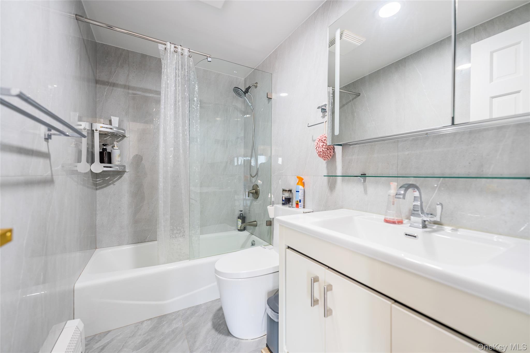 43-18 Main Street, Unit 12A Queens, NY 11355 - Photo 23 of 32 a bathroom with a sink a toilet and a bathtub