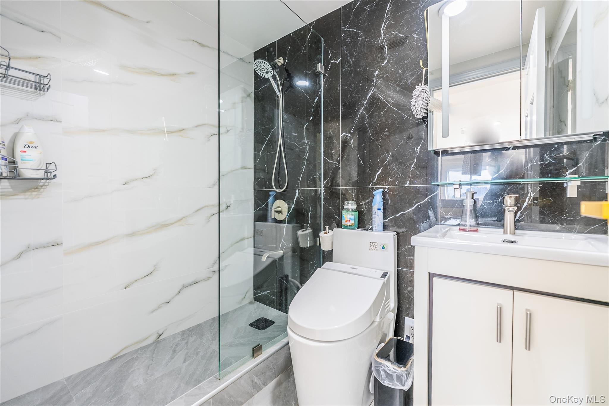 43-18 Main Street, Unit 12A Queens, NY 11355 - Photo 29 of 32 a bathroom with a sink toilet and shower