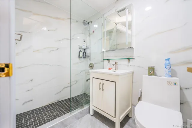 a bathroom with a sink toilet and shower