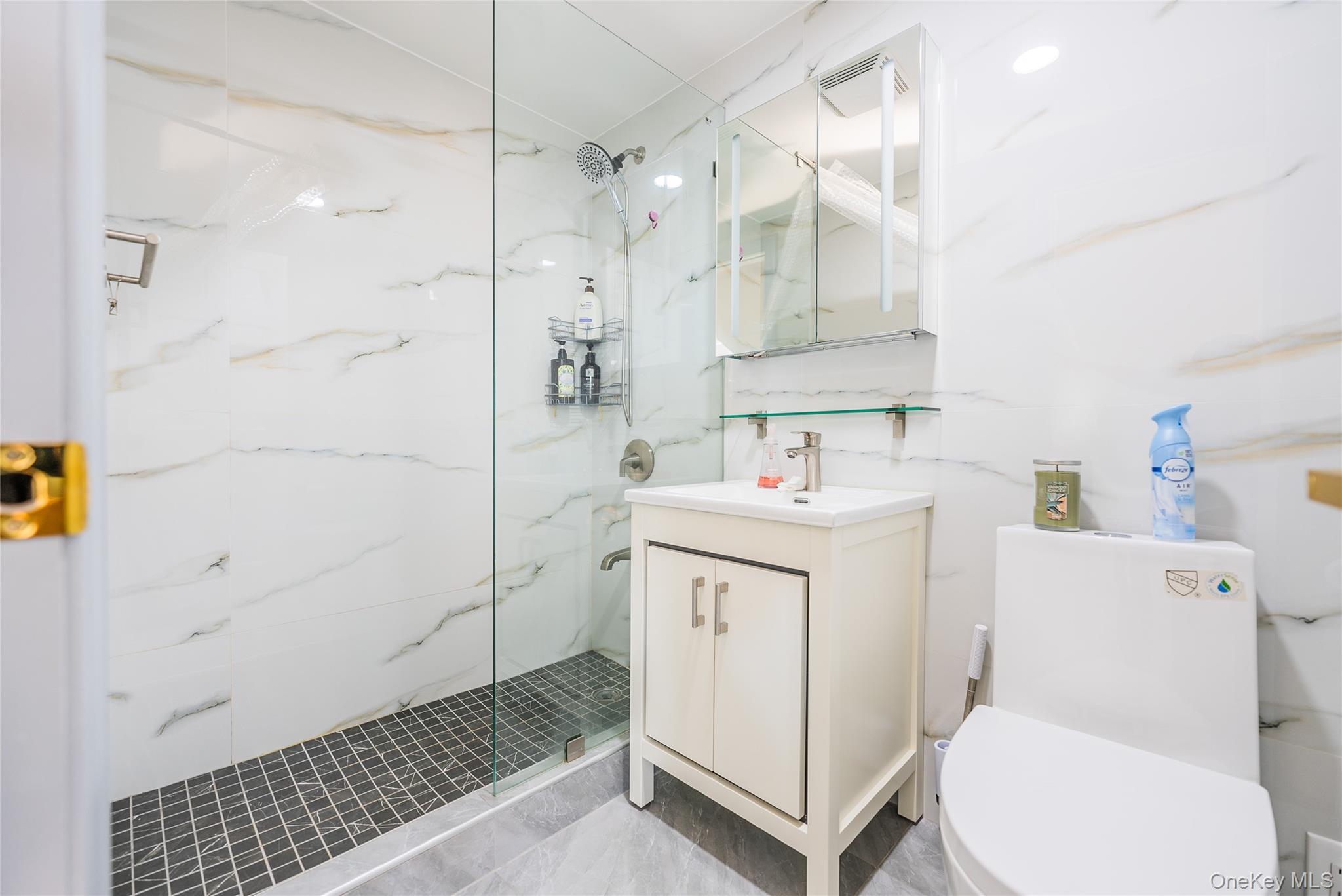 43-18 Main Street, Unit 12A Queens, NY 11355 - Photo 30 of 32 a bathroom with a sink toilet vanity and shower