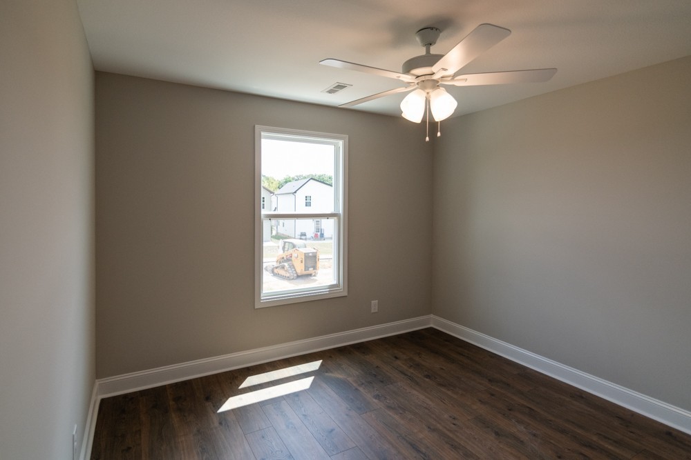 620 Southern Pass Run Clarksville, TN 37043 - Photo 13 of 21 an empty room with wooden floor fan and windows