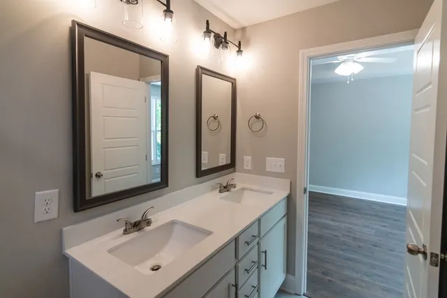 a bathroom with a sink vanity and mirror