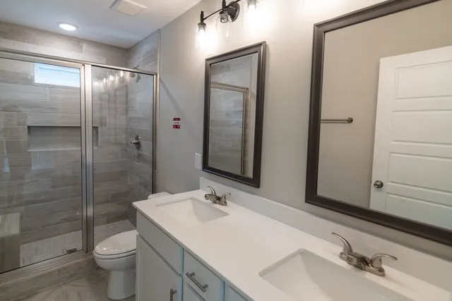 a bathroom with a sink toilet and shower