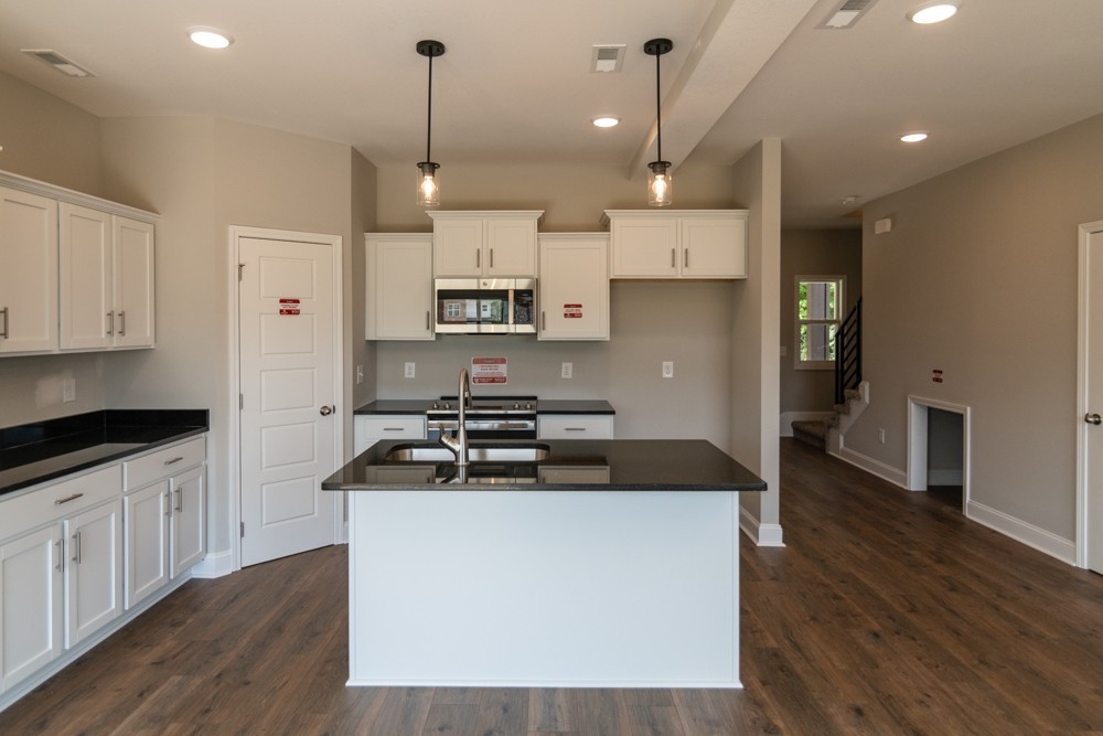 620 Southern Pass Run Clarksville, TN 37043 - Photo 6 of 21 a kitchen with kitchen island a sink stainless steel appliances and wooden floor