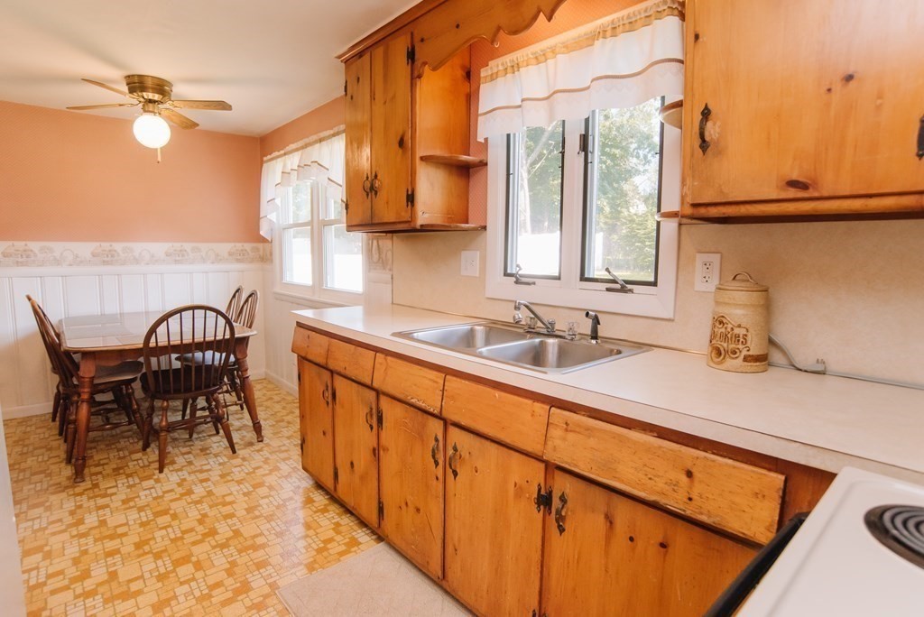 37 Timothy Circle Springfield, MA 01119 - Photo 7 of 37 a kitchen with stainless steel appliances granite countertop sink a table and chairs