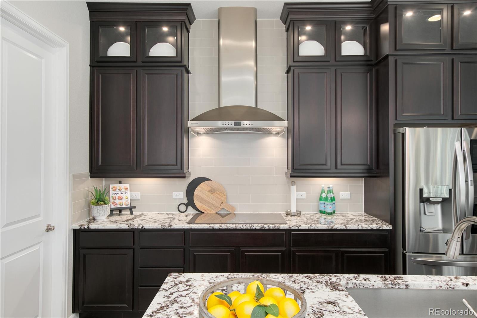 1165 Brocade Drive Highlands Ranch, CO 80126 - Photo 13 of 40 a kitchen with a refrigerator and cabinets