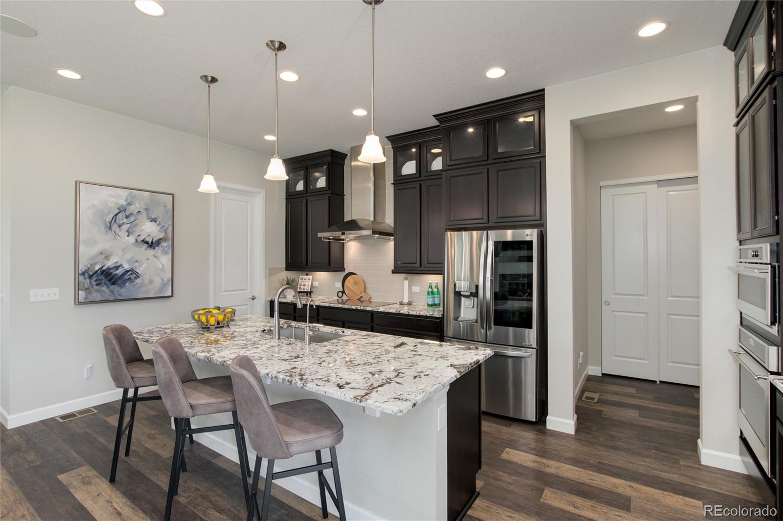 1165 Brocade Drive Highlands Ranch, CO 80126 - Photo 14 of 40 a kitchen with a table and chairs in it