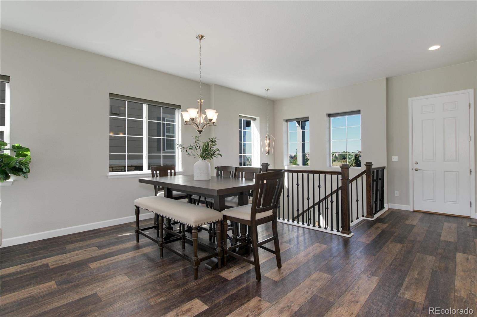 1165 Brocade Drive Highlands Ranch, CO 80126 - Photo 18 of 40 a view of a dining room with furniture window and wooden floor