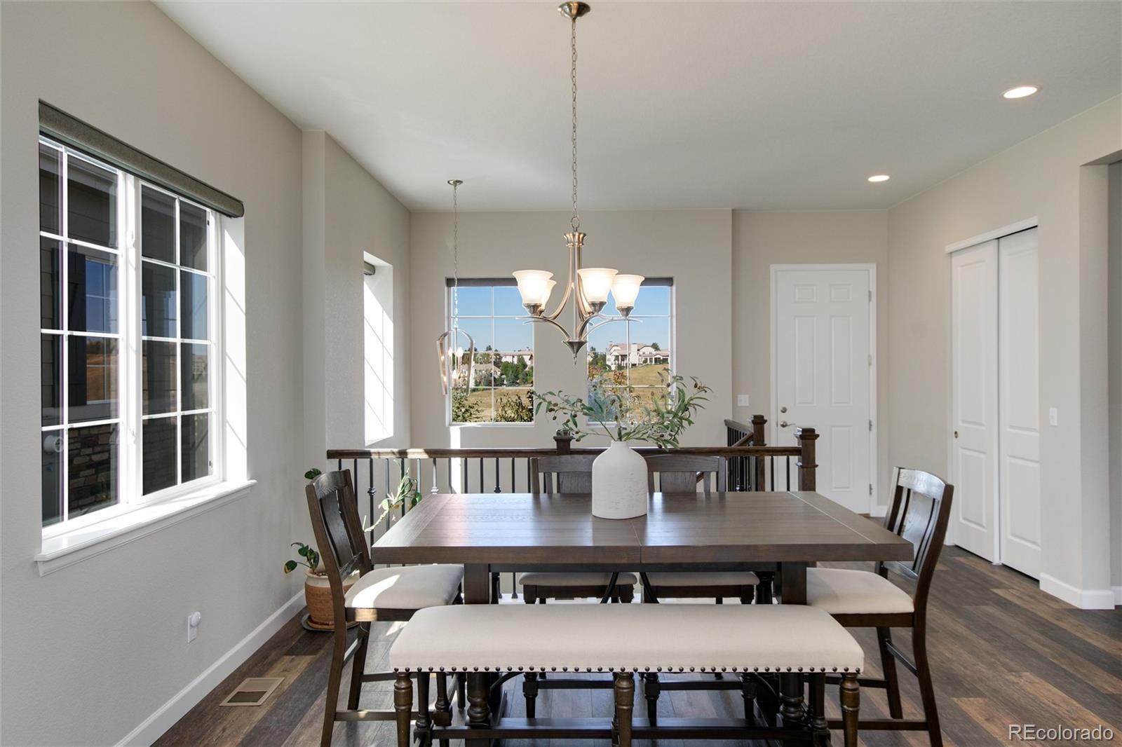 1165 Brocade Drive Highlands Ranch, CO 80126 - Photo 19 of 40 a view of a dining room with furniture window and wooden floor